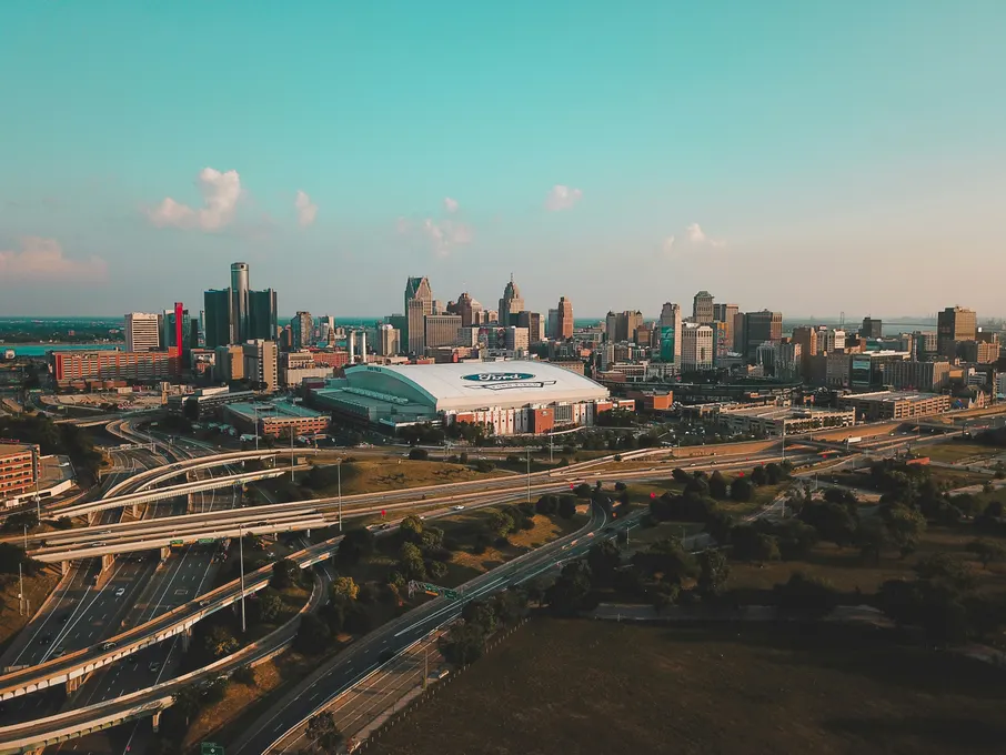 Downtown Detroit from the air, with a domed stadium and freeway interchanges in front