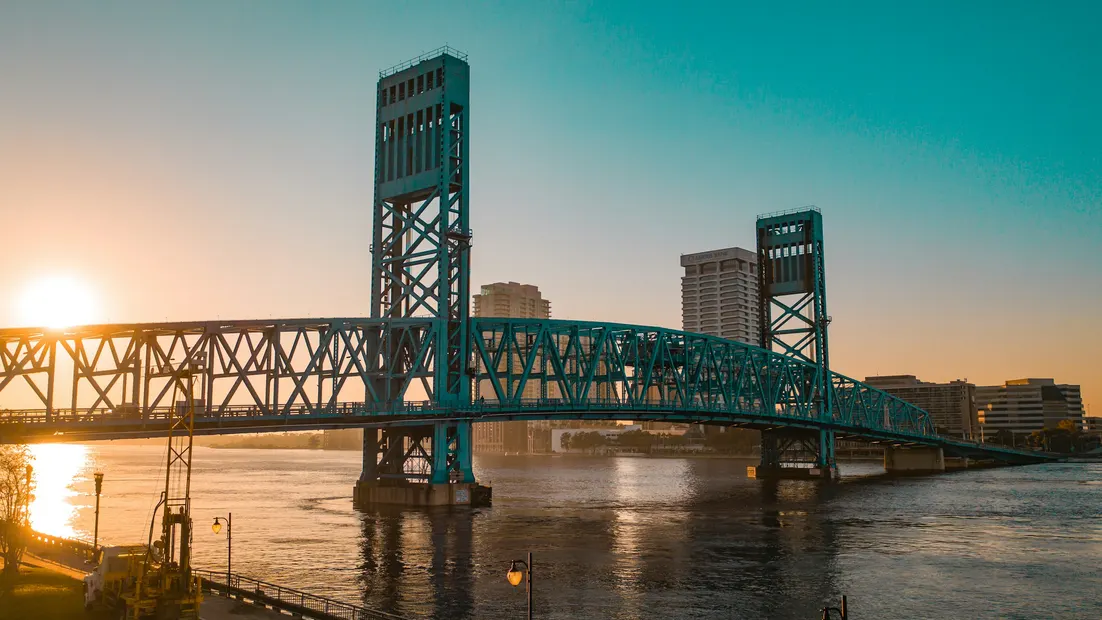 A steel lift bridge over the river in downtown Jacksonville at sunrise