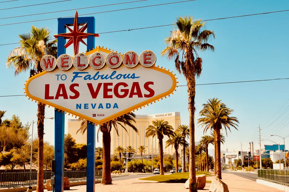 The Welcome to Fabulous Las Vegas sign under palm trees